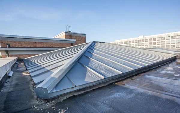 Standing seam metal roof ridge detail on a commercial building